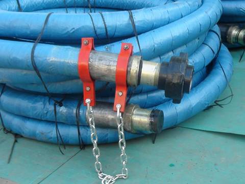 two rolls of rotary drilling hoses wrapped with blue package paper are on the ground.